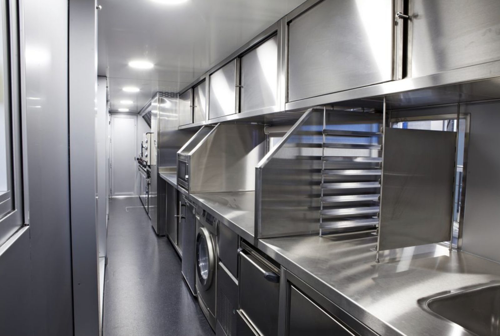 Stainless steel galley with prep counters, tray racks and ovens